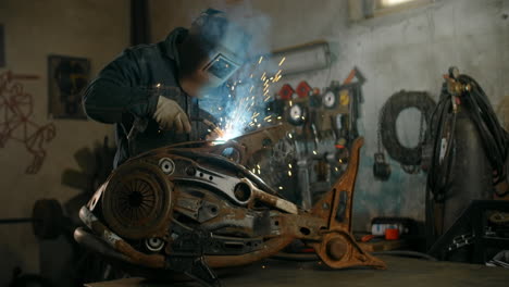welding a fish sculpture from recycled metal