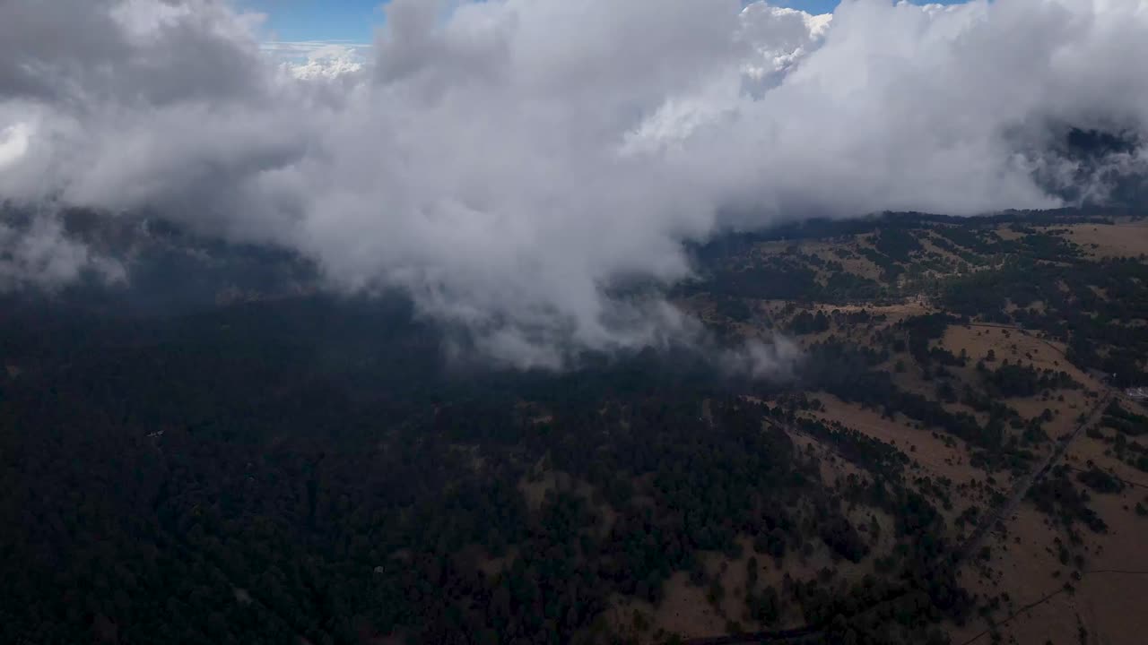 Aerial shot of the mountain pass known as 'Paso de Cortés' at 3,700 meters above sea level on the outskirts of Mexico City, with a cloud bank at the top