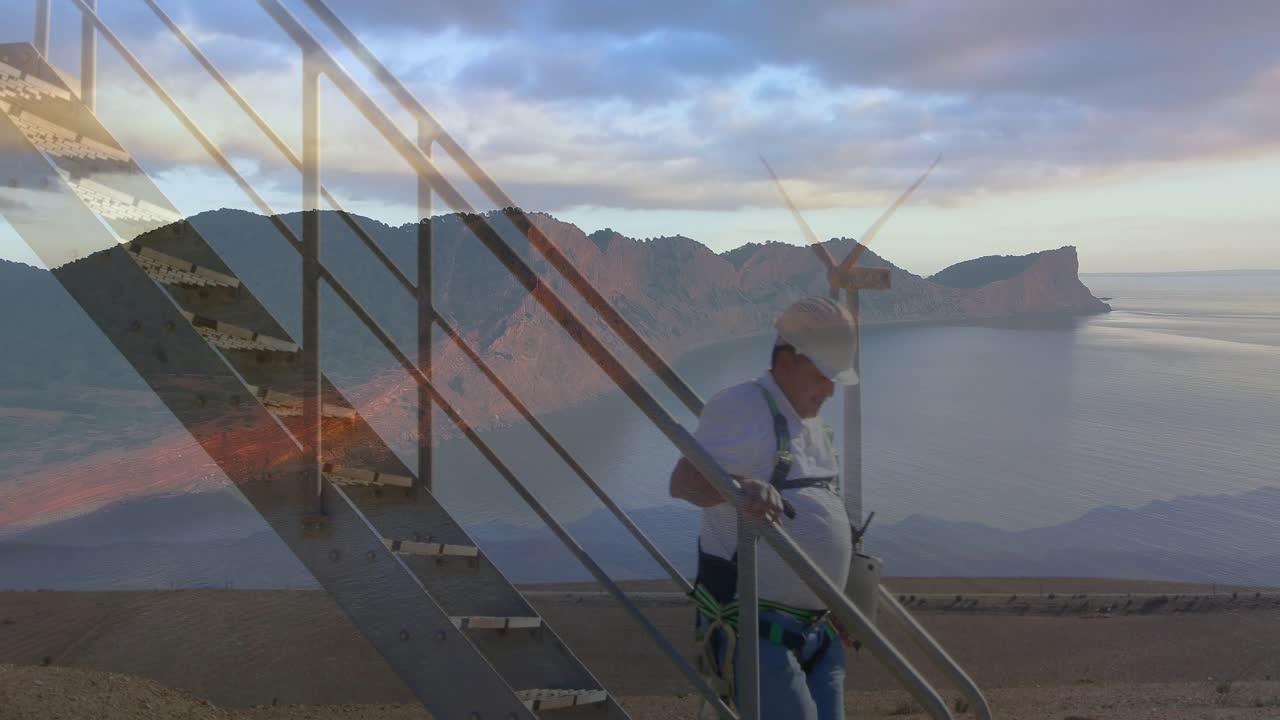 Male tech descending stairs after finishing check at turbine steadying rail fixing harness fading