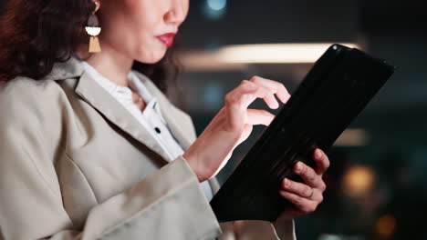 businesswoman using tablet at night