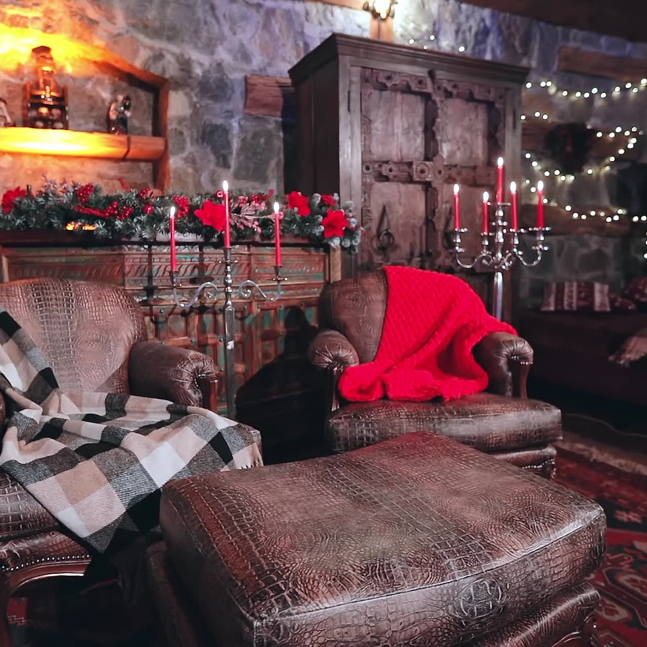 Cozy sitting room with Christmas decor. Beautiful old furniture in the living room. Comfortable armchairs and candlesticks for New year celebration in the house