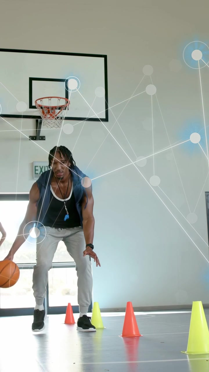 Vertical video: Pro picking up ball starting cone drill on court, causing AR nodes showing training