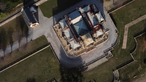 aerial view of an abandoned mansion in a park