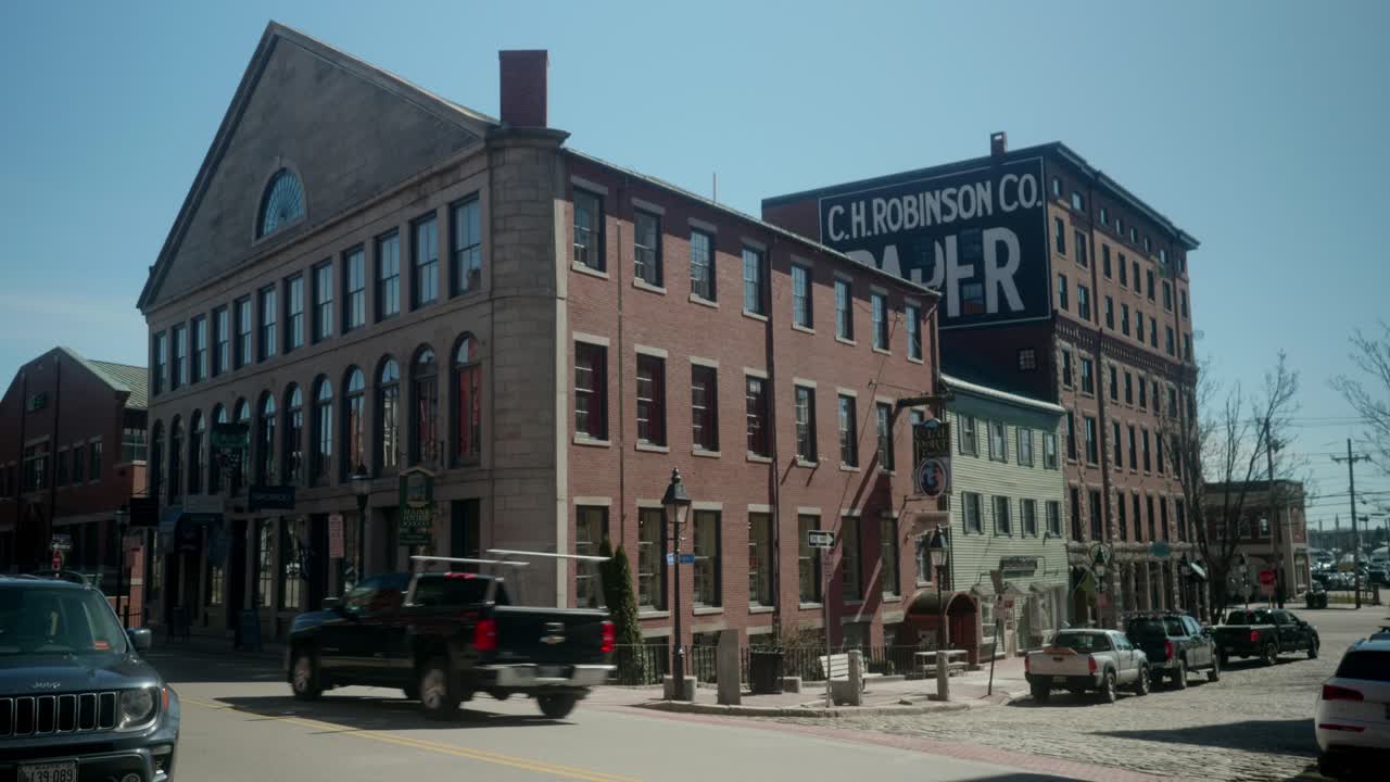 Steady view of Mariner's church banquet center with parked cars nearby, under clear blue sky in Portland, Maine, USA.
