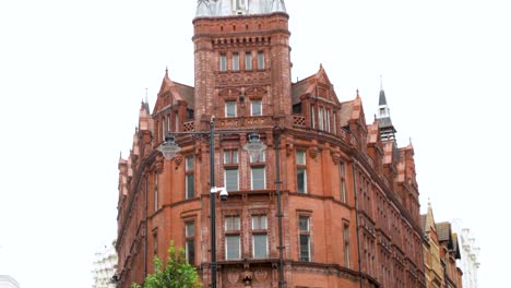 establishing shot of a posh, red brick apartment-office building