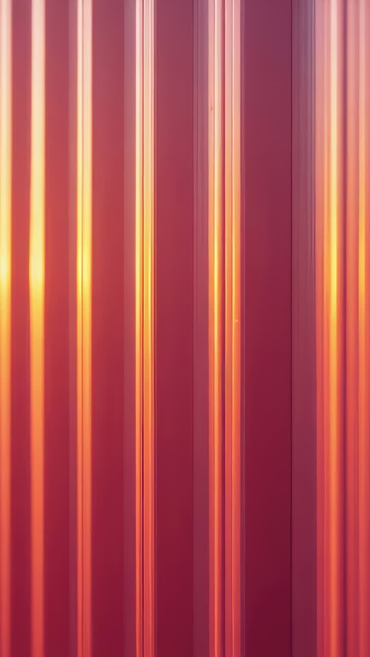 Vertical video: Shifting low sun making narrow reflections on corrugated metal panels in closeup
