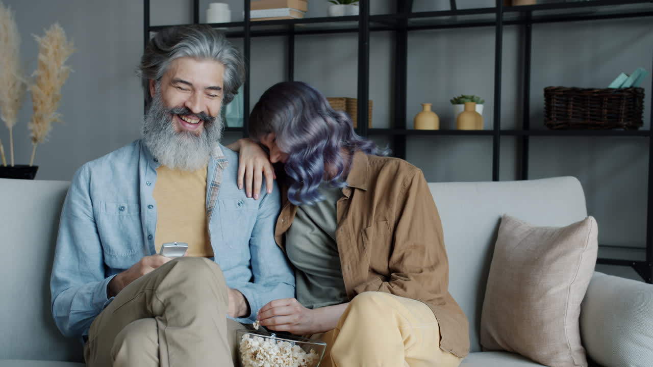 Elderly Couple Enjoying Movie Night at Home