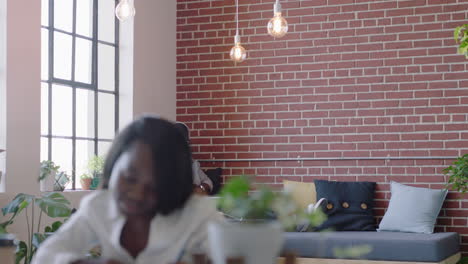 young african american student man studying preparing for college exam browsing online research on laptop computer drinking coffee ejoying listening to music in office
