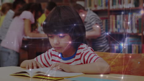 glowing network of connections against boy studying in library at school