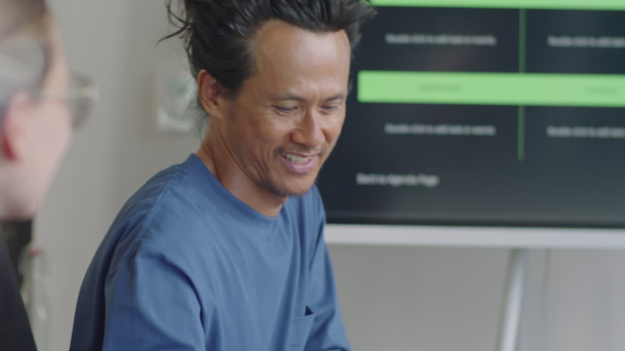 Asian Team Leader Speaking with Colleague on Business Meeting