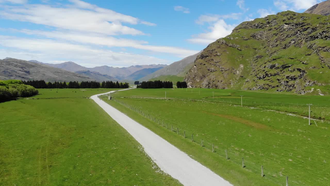 Drone, aerial views of car driving through mountains in New Zealand