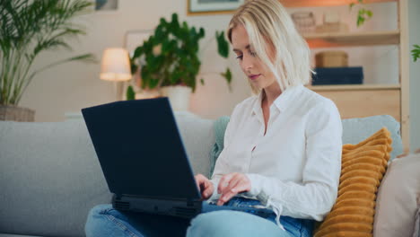 girl writes email on laptop at home