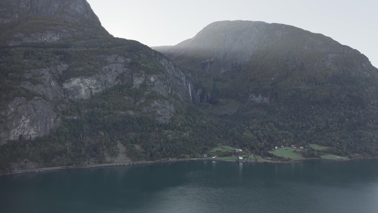 Light from the Sun falling on Luster fjord over mountains. Drone footage