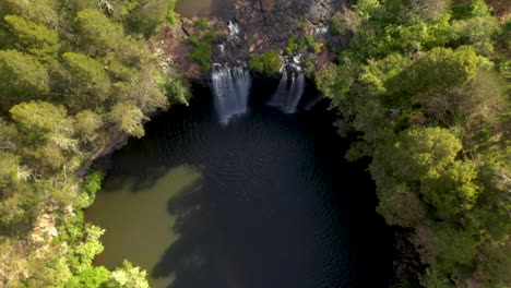 Rising-downward-angle-drone-shot-of-Dangar-Falls-Australia