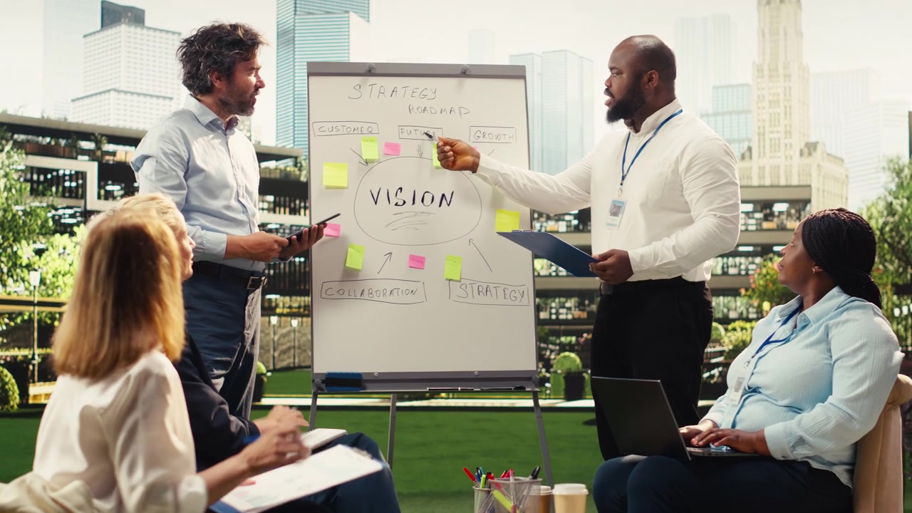 Diverse business presenters explaining vision board with sticky notes
