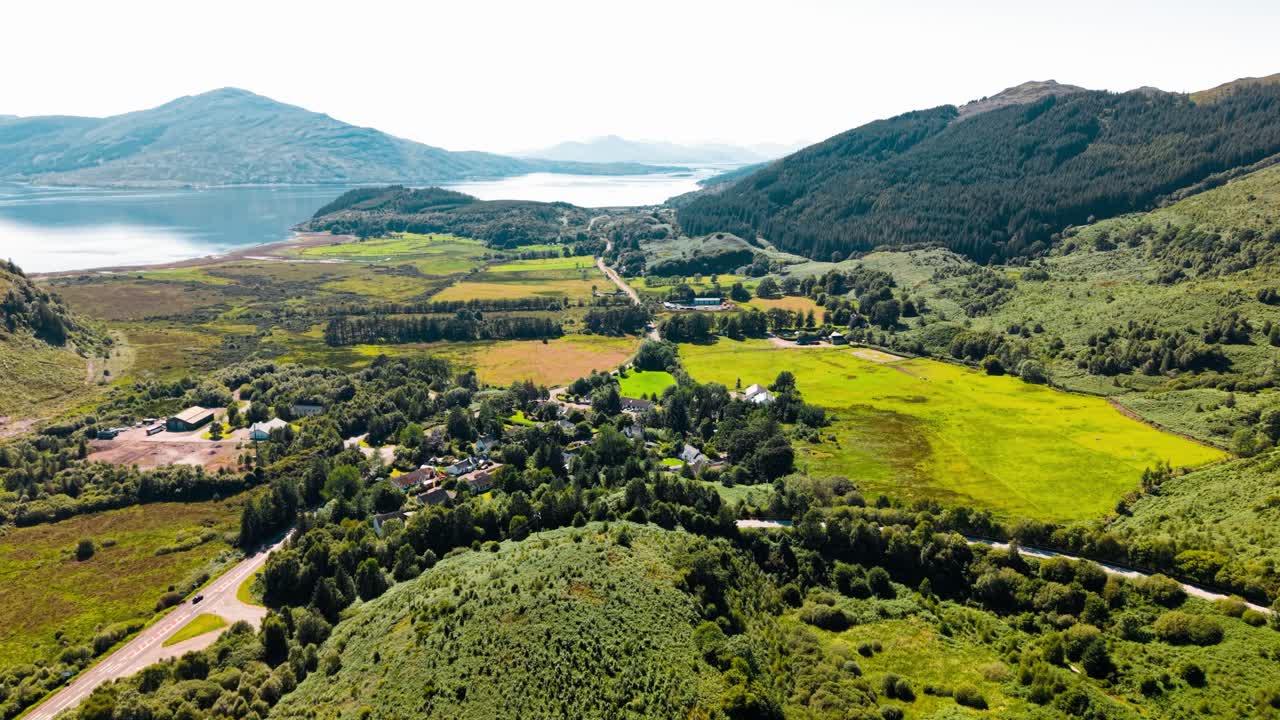 Scenic Aerial View of Mountains, Lake, and Rural Landscape