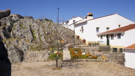 view of marvao village with beautiful houses and church with rocky landscape mountains behind