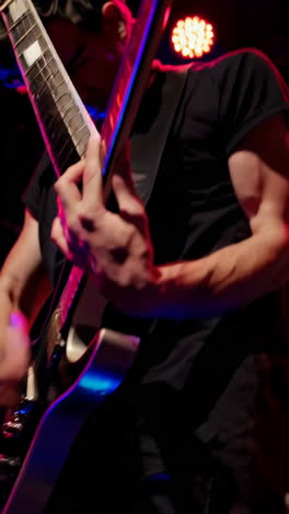 musician playing electric guitar on stage