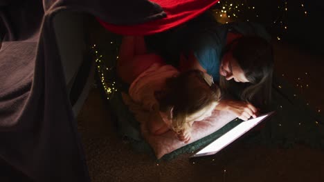 caucasian mother and daughter having fun using digital tablet