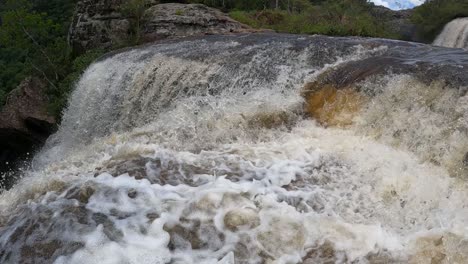 strong movement of water in a waterfall with rapids, shot in slow motion