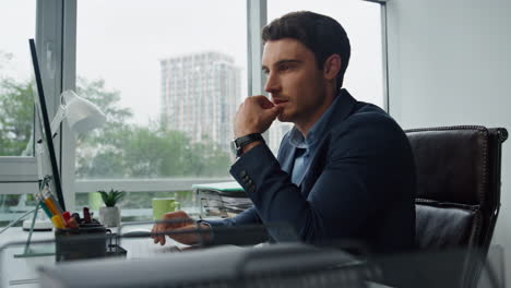 pensive worker working computer in office closeup. happy manager solving problem