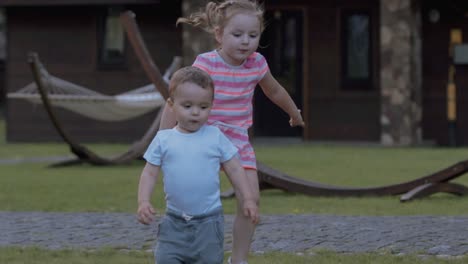 toddler girl and boy play in slow motion