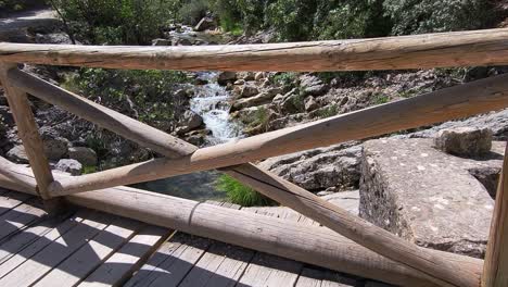 wooden bridge over the river. wooden footbridge spanning the stream. first person view. rio borosa. spain