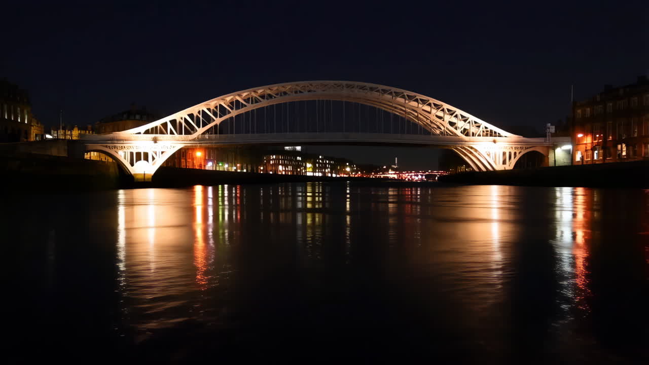 Illuminated Bridge Reflected in Water at Night