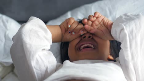 a upset child girl cover her face with hand