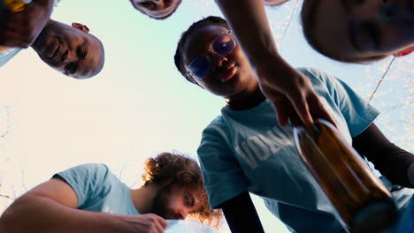 POV-of-volunteers-team-collecting-rubbish-in-blue-garbage-bags