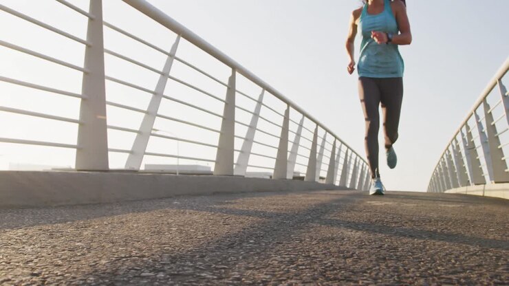 Young woman running on a bridge