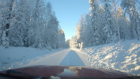 windscreen view driving through a beautiful snowy winter wonderland