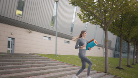 woman exercising and drinking water outside