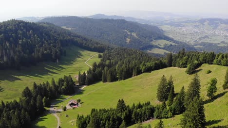 hut by hiking trail in peaceful alpine valley in switzerland, aerial