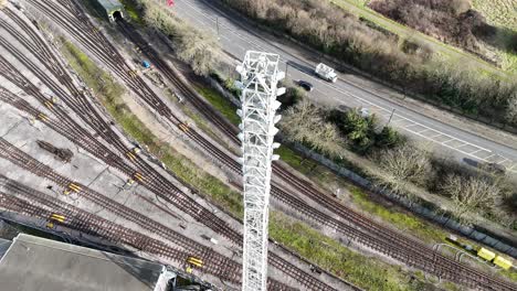 Communications tower and railway lines Overhead birds eye drone aerial view