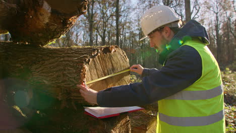 Beautiful countryside morning. Employee measuring and documentating data
