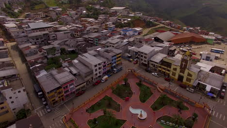 ecuadorian town's city center with misty mountain side in distance