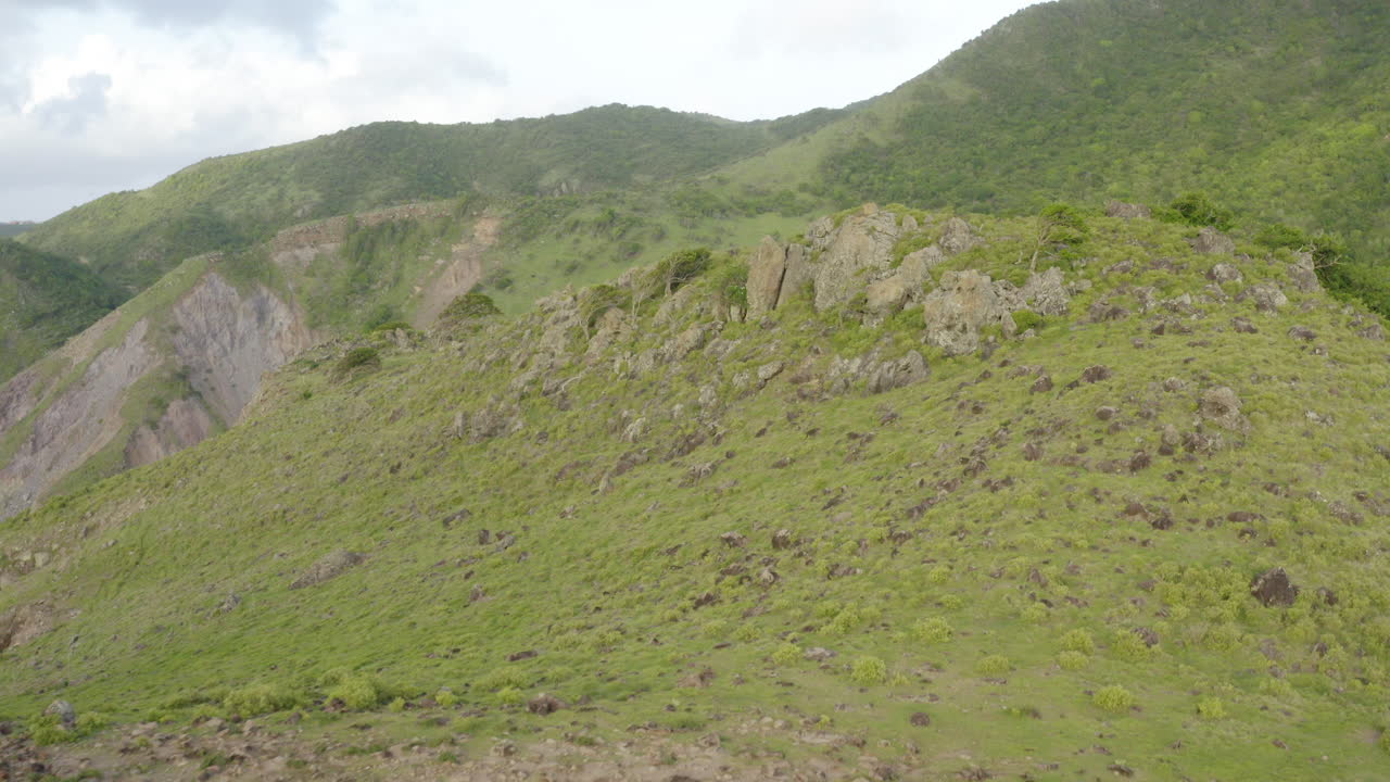 Abandoned Caribbean beach, dawn. Smooth fly out, first showing a rock formation surrounded by foliage, mountains in the distance, then reveal a cliffside with a long beach.
4K UHD at 23.98 fps.