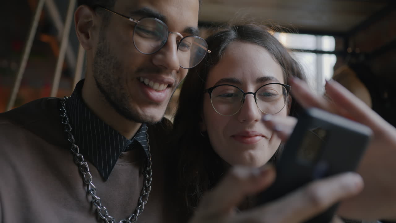 Young couple using a smartphone in a cafe