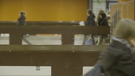People Walking Through Supermarket Checkout Area