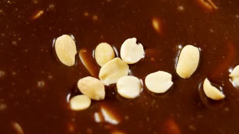 peanuts being mixed in melted chocolate 4k