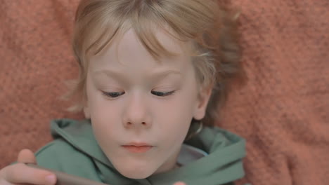 retrato de niño pequeño con un teléfono inteligente viendo una película