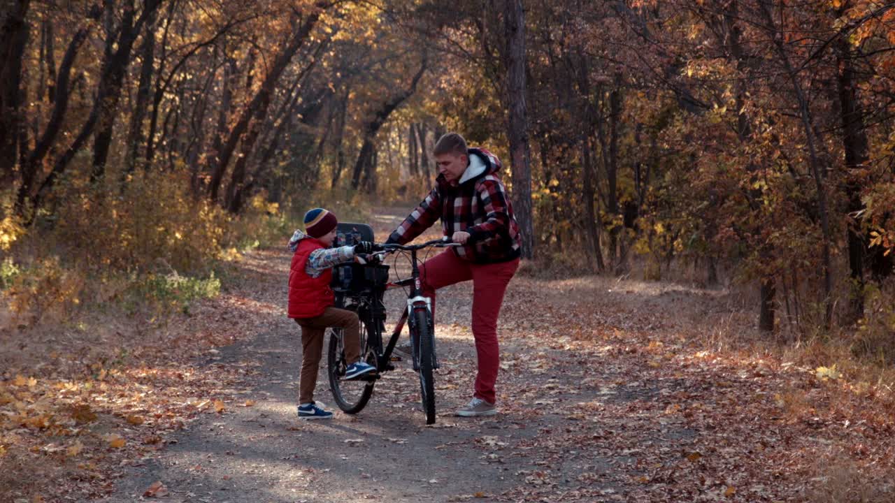 The Father Shows To The Son The Bicycle Device