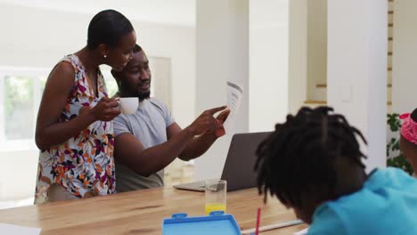 African-american-couple-calculating-finance-and-using-computer-at-home