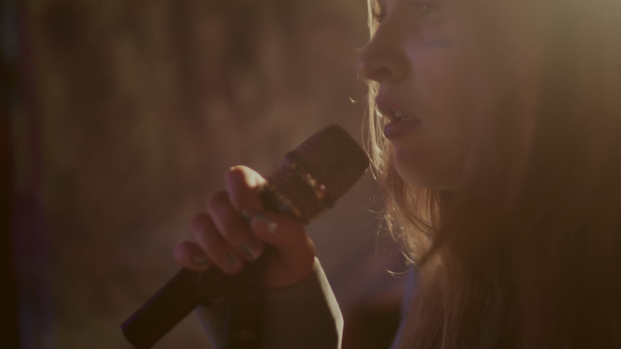 무대에서 마이크로 노래하는 여자