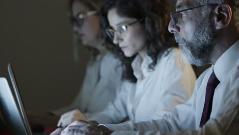 business people in eyeglasses working at night