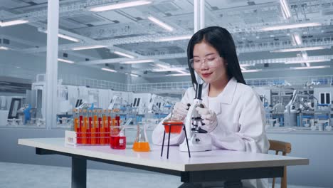 side view of asian woman scientist looking through microscope on the table with test tube smiling and crossing her arms in a laboratory, working in the lab analyzing samples under microscope
