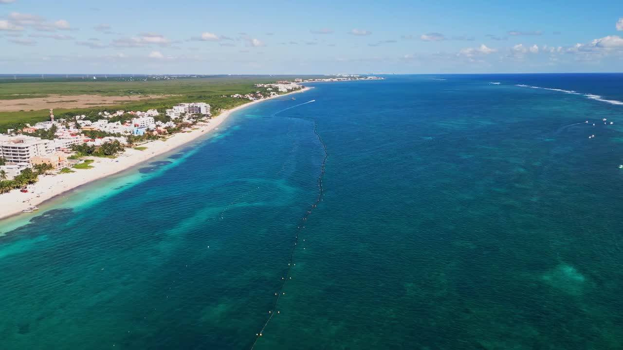 Aerial view of blue ocean near Puerto Morelos, Mexico under clear skies