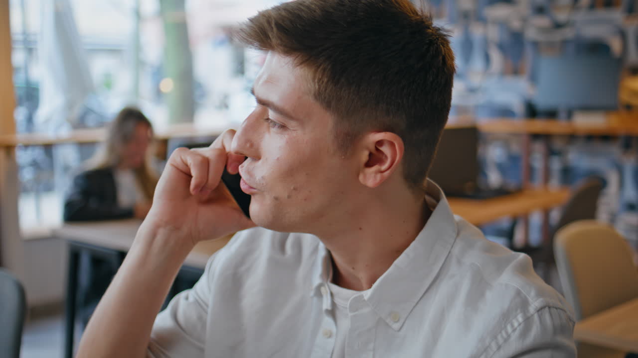 Joyful programmer cellphone call speaking at office closeup. Happy man talking