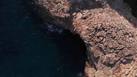 AERIAL:-Looking-down-to-fissured-coast-in-spain-next-to-pool-houses